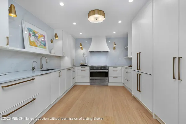 a kitchen with stainless steel appliances a stove a sink and a refrigerator