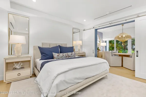 a bedroom with a large bed and a large window