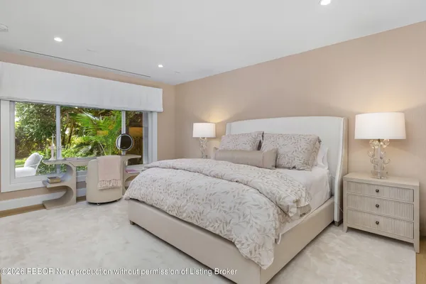 a bed room with a bed and large window
