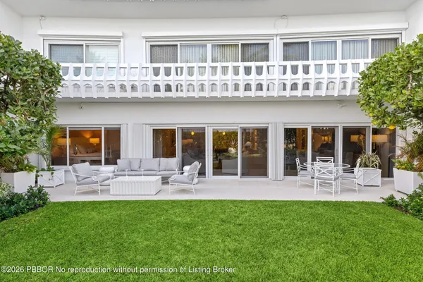 a front view of house with a garden and patio