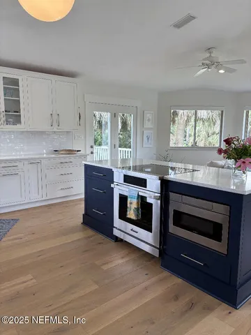 a kitchen with stainless steel appliances granite countertop a stove and a sink