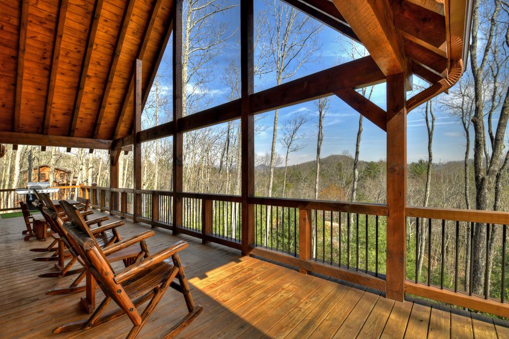 91 Heritage Way Cherry Log, GA 30522 - Photo 13 of 35 a view of a balcony with couch and wooden floor