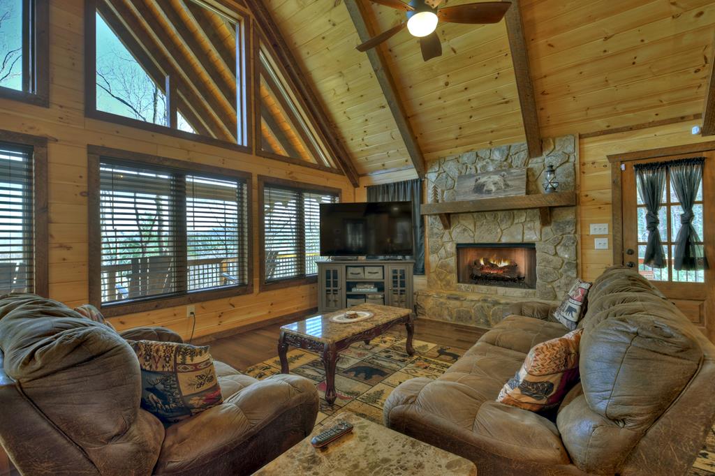 91 Heritage Way Cherry Log, GA 30522 - Photo 17 of 35 a living room with furniture a fireplace and a flat screen tv