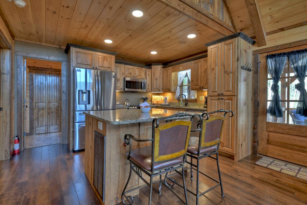 91 Heritage Way Cherry Log, GA 30522 - Photo 21 of 35 a kitchen with kitchen island granite countertop wooden floors cabinets and stainless steel appliances