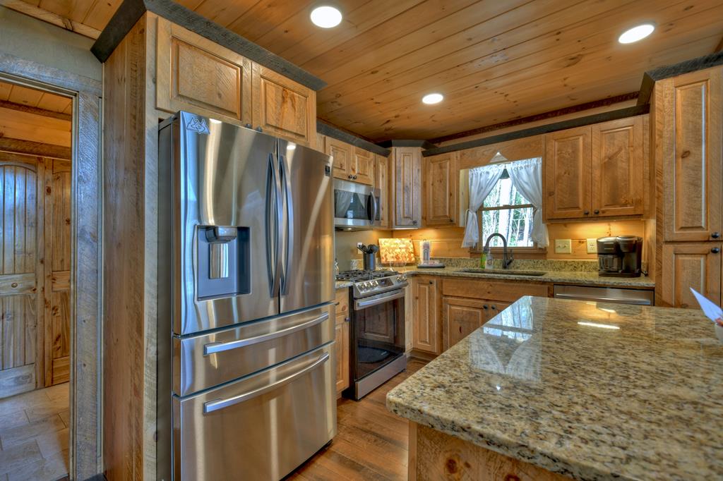 91 Heritage Way Cherry Log, GA 30522 - Photo 22 of 35 a kitchen with stainless steel appliances granite countertop a refrigerator a stove and a sink