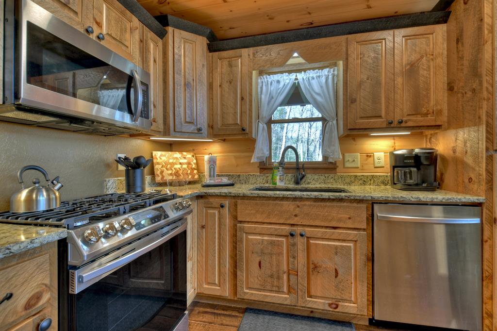 91 Heritage Way Cherry Log, GA 30522 - Photo 23 of 35 a kitchen with stainless steel appliances granite countertop a stove a sink and a microwave