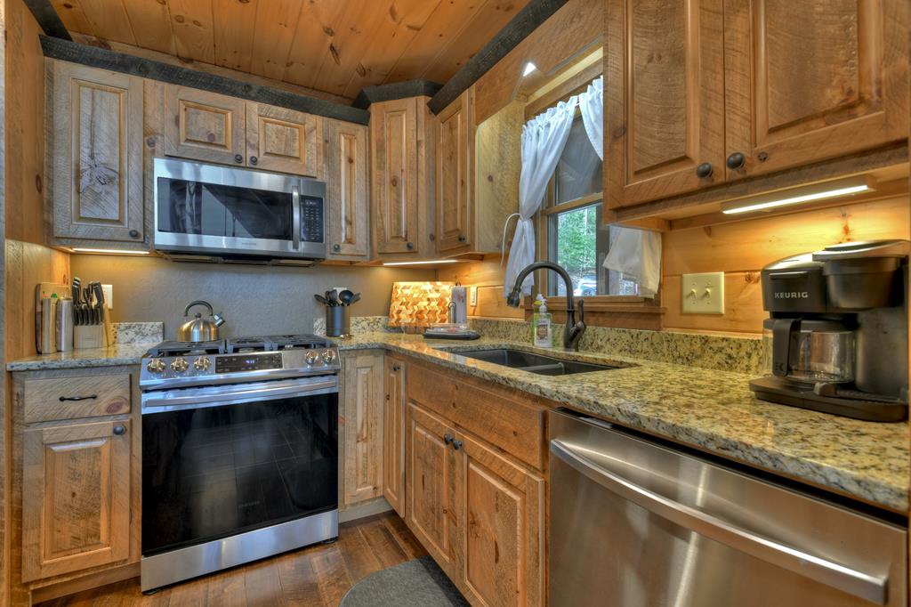 91 Heritage Way Cherry Log, GA 30522 - Photo 24 of 35 a kitchen with stainless steel appliances granite countertop a sink stove and microwave