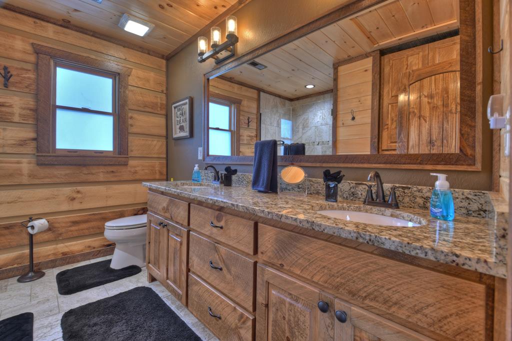 91 Heritage Way Cherry Log, GA 30522 - Photo 29 of 35 a bathroom with a granite countertop sink mirror and toilet