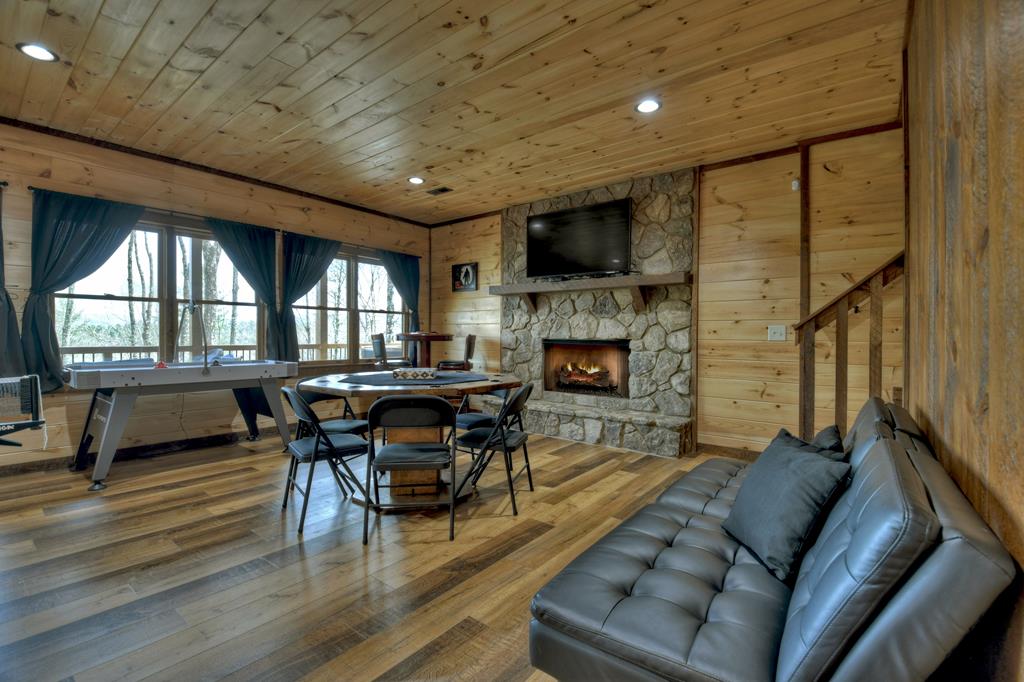91 Heritage Way Cherry Log, GA 30522 - Photo 30 of 35 a living room with furniture a fireplace and a flat screen tv