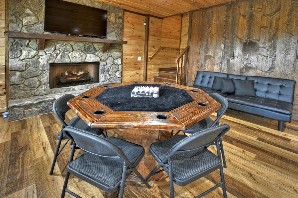 91 Heritage Way Cherry Log, GA 30522 - Photo 31 of 35 a living room with furniture a flat screen tv and a fireplace