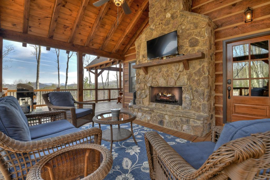 91 Heritage Way Cherry Log, GA 30522 - Photo 8 of 35 a living room with furniture a fireplace and a flat screen tv