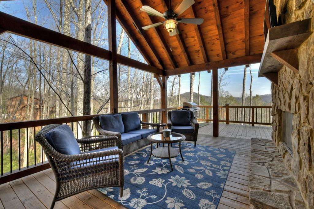 91 Heritage Way Cherry Log, GA 30522 - Photo 9 of 35 a living room with furniture a rug and a floor to ceiling window