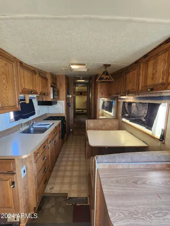a kitchen with stainless steel appliances granite countertop a sink a stove counter space and cabinets