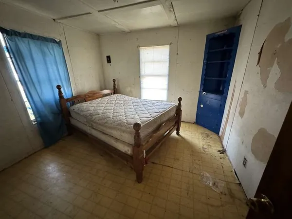 a bed sitting in a room next to a window