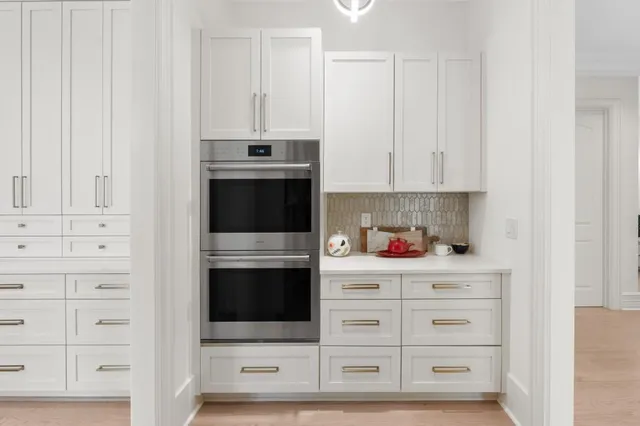 a spacious bedroom with a bed a couch and a window