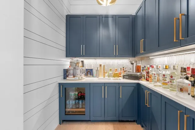 a spacious bedroom with a bed and a chandelier