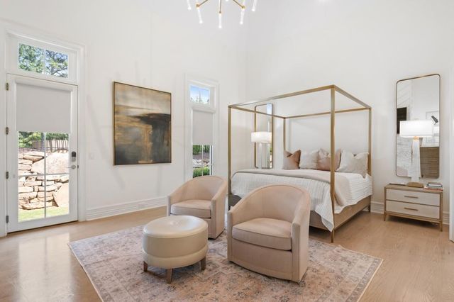 a spacious bathroom with a double vanity sink a mirror and a bathtub