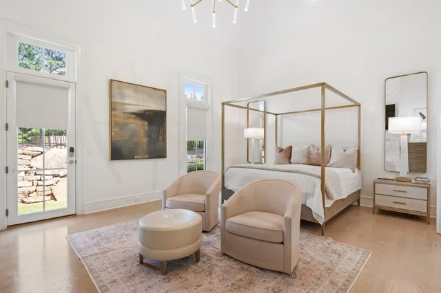 a spacious bathroom with a double vanity sink a mirror and a bathtub