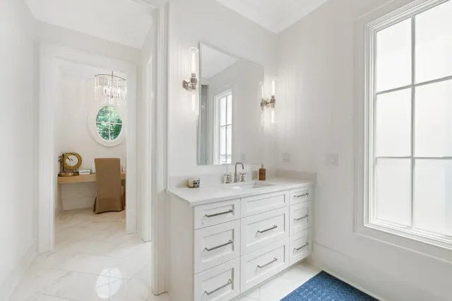 a bathroom with a granite countertop sink a toilet and a shower