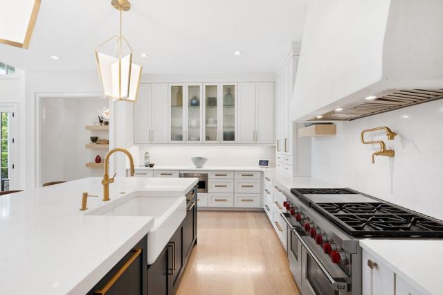 a kitchen that has a sink and a stove
