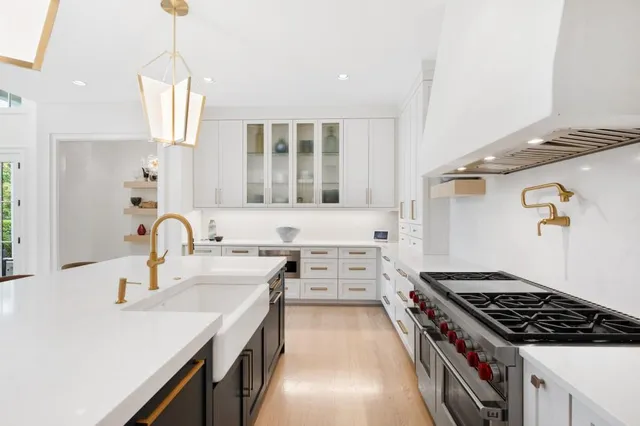 a kitchen that has a sink and a stove