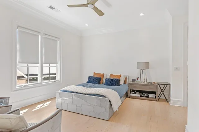 a bedroom with a bed and painting on the wall