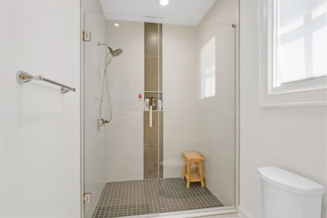 a front view of a house with swimming pool having outdoor seating