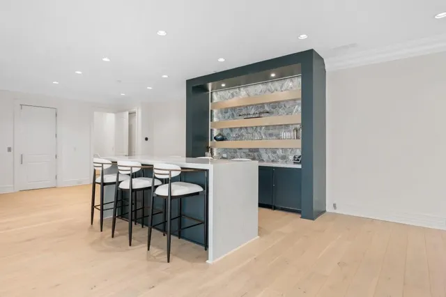 a view of a patio with table and chairs and potted plants