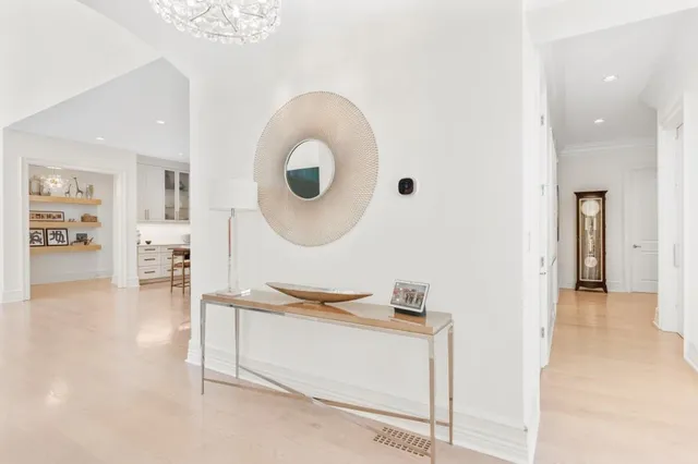 a dining room with furniture a fireplace a rug and a chandelier
