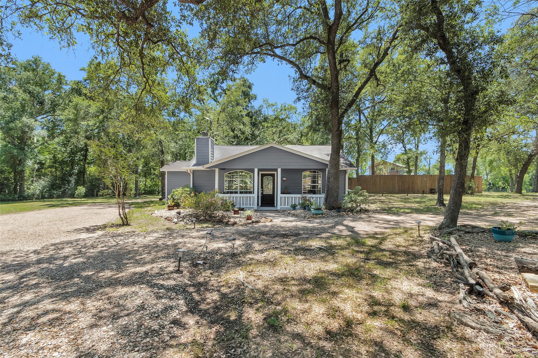 38805 Wyatt Chapel Road Hempstead, TX 77445 - Photo 3 of 50 Charming single-story home surrounded by mature trees, featuring a covered front porch and spacious yard. Ideal for those seeking a serene, nature-filled setting.