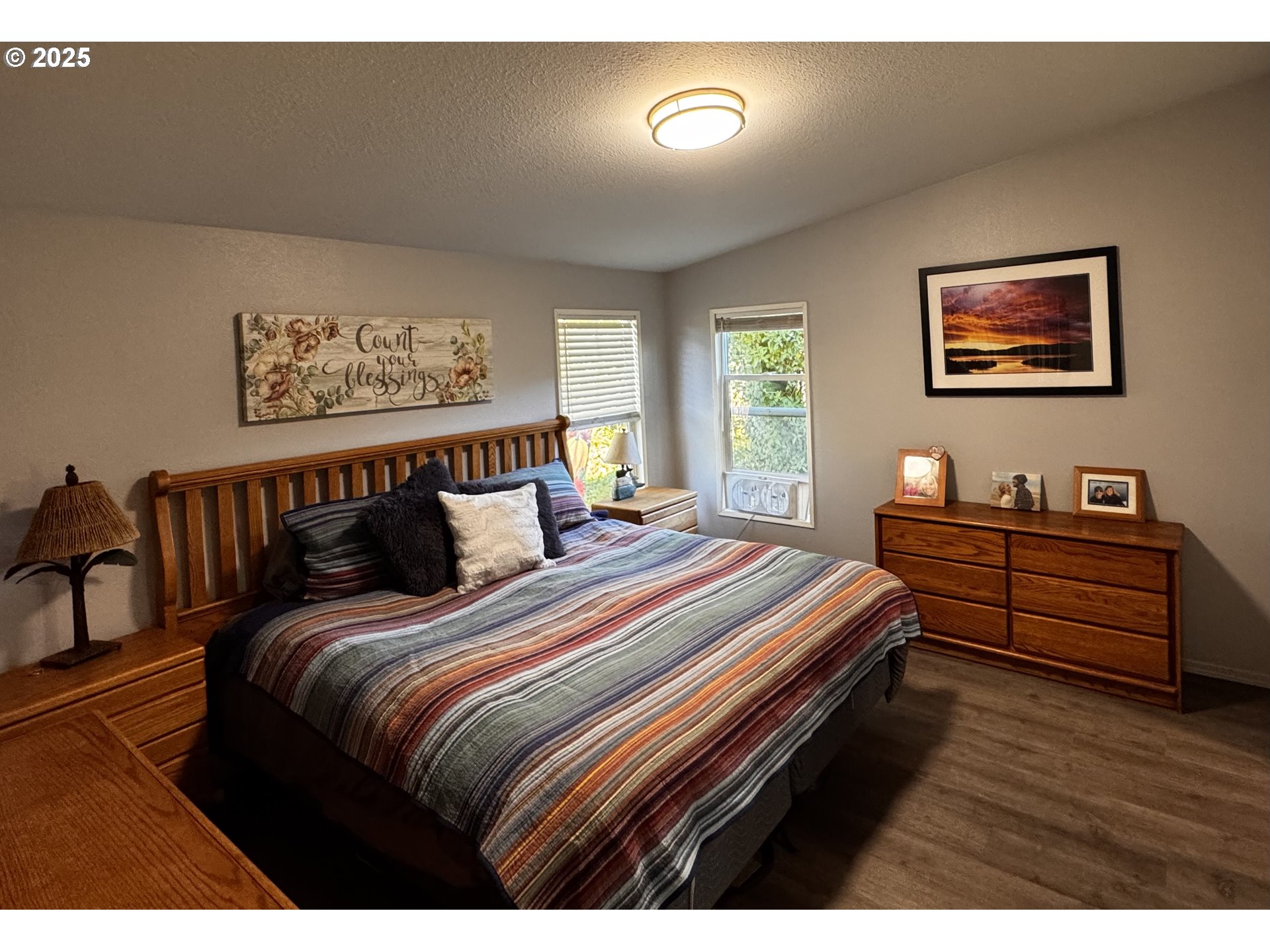97818 Hanscam Lane Brookings, OR 97415 - Photo 15 of 44 a bedroom with bed and wooden floor