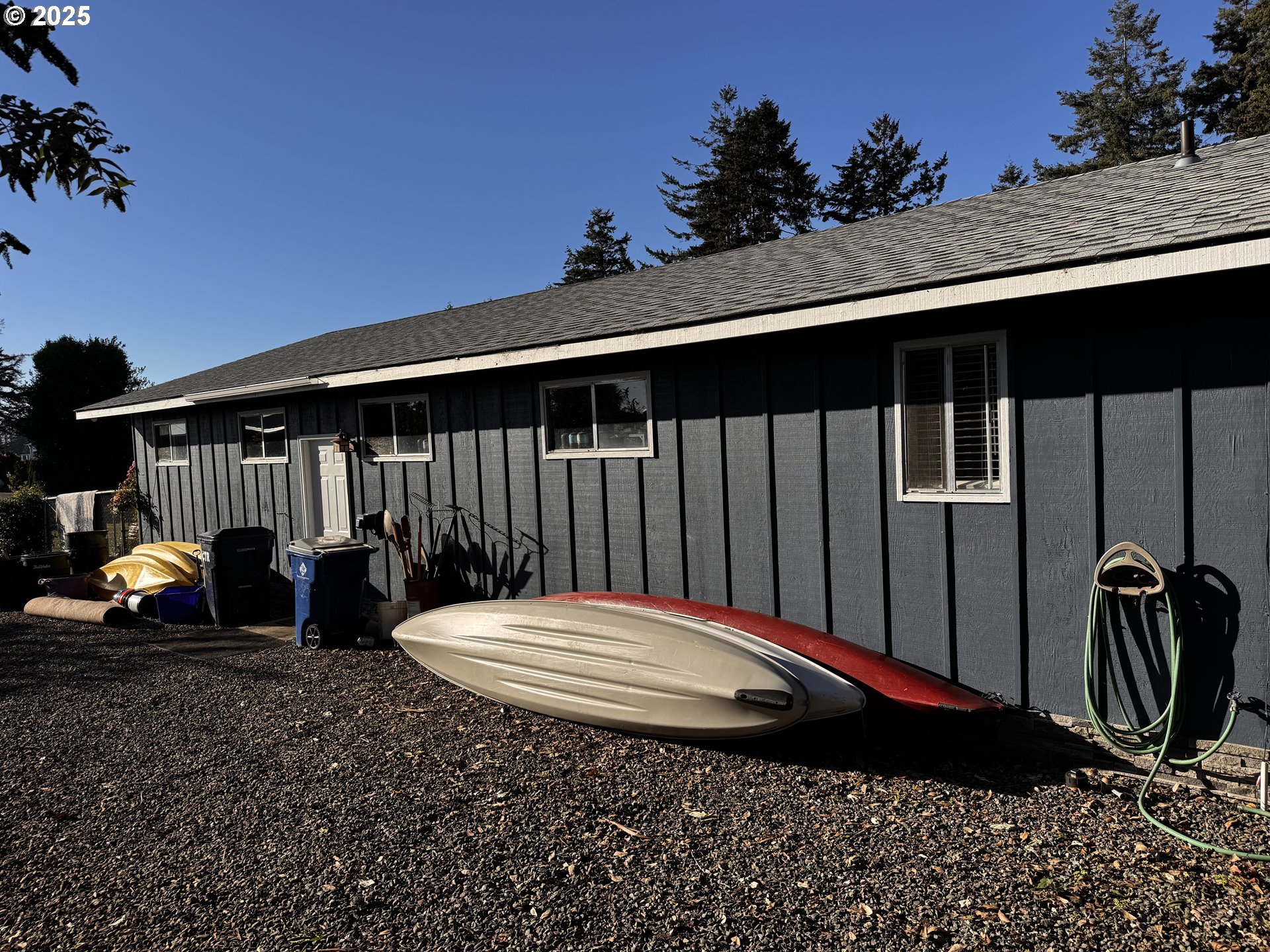 97818 Hanscam Lane Brookings, OR 97415 - Photo 24 of 44 a backyard of a house with table and chairs