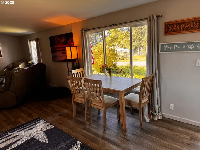 a dining room with furniture and wooden floor