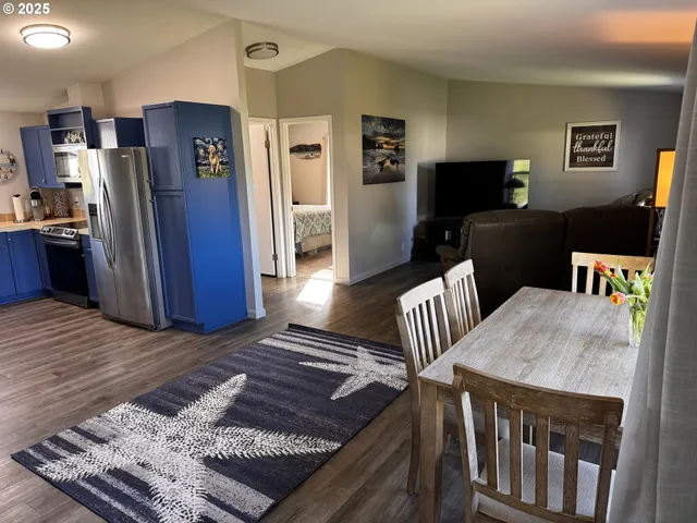 a view of kitchen with furniture and stainless steel appliances