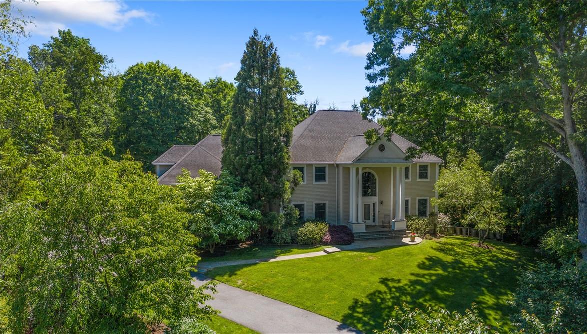 Welcome to 7 Boulder Trail, Chappaqua, a stately, refined, custom-built Colonial commandingly set on 1.6 acres in sought-after Hardscrabble Lake.