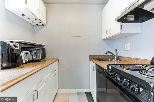 a kitchen with stainless steel appliances granite countertop a stove and a microwave