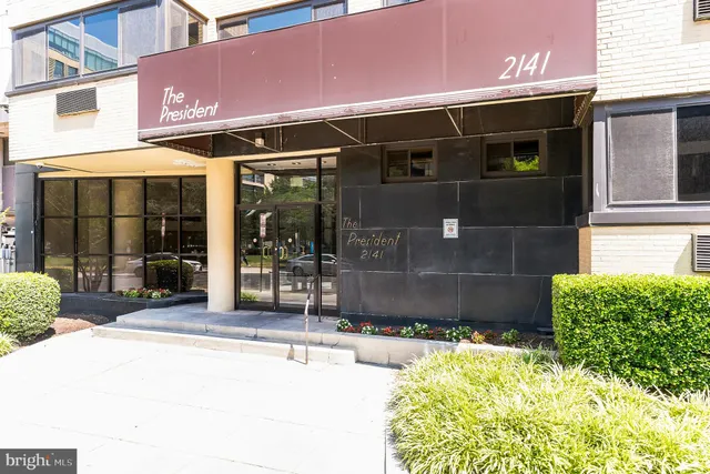 a front view of a building with a garden