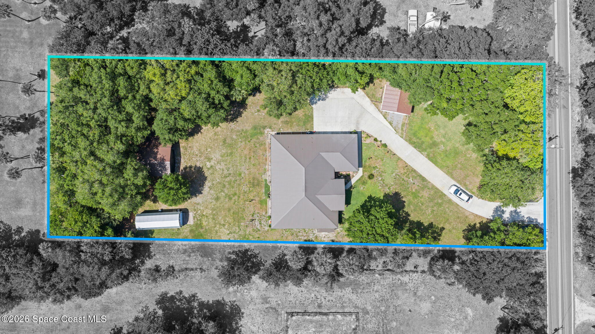 1740 Ford Road Mims, FL 32754 - Photo 42 of 43 an aerial view of a house with a yard and a garden
