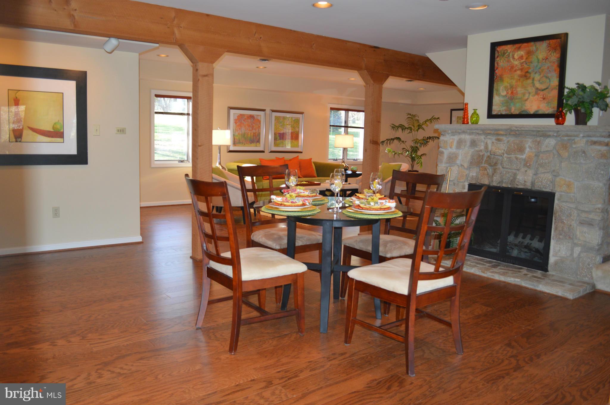 22524 Shiloh Church Road Boyds, MD 20841 - Photo 6 of 20 a dining room with furniture a fireplace and wooden floor