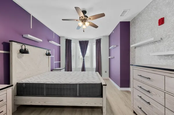 a living room with furniture and ceiling fan