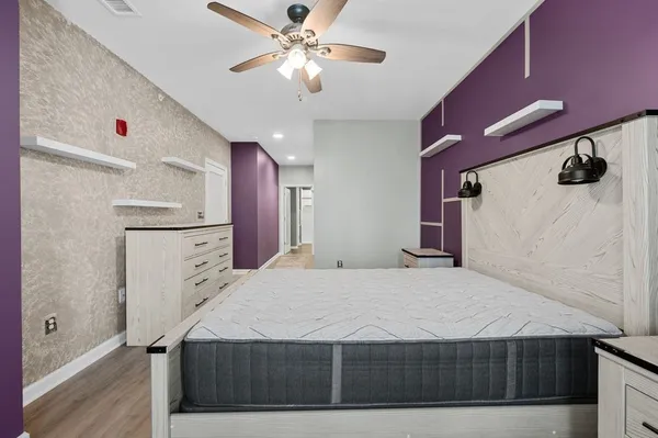 a bedroom with a bed and a chandelier