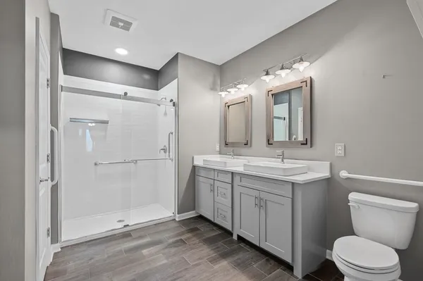 a bathroom with a toilet sink and mirror