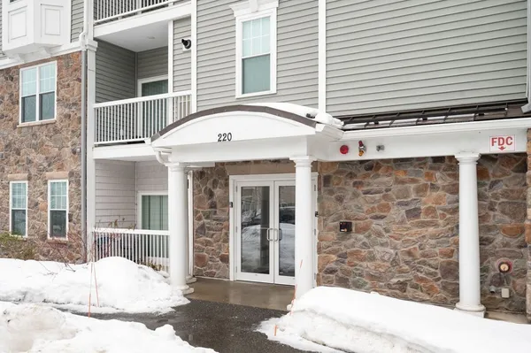a view of a brick house with large windows