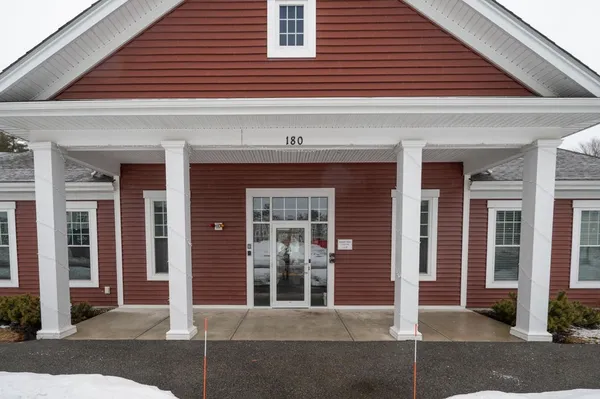 a living room with furniture and a gym machine