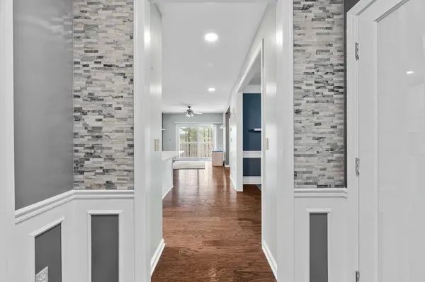 a view of a hallway with a dining table and chairs