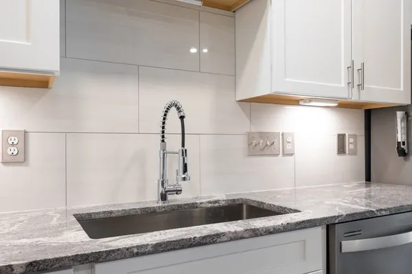 a kitchen with a sink and cabinets