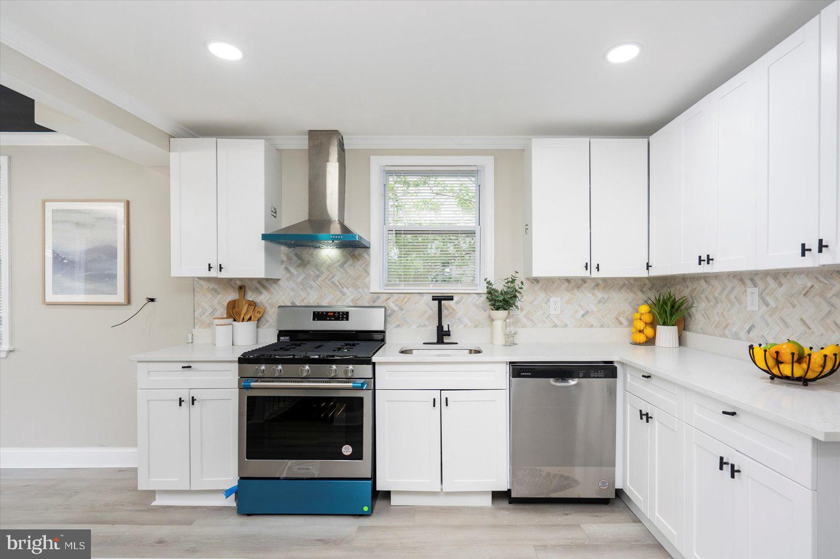 8121 Hillendale Road Parkville, MD 21234 - Photo 10 of 47 a kitchen with white cabinets and appliances