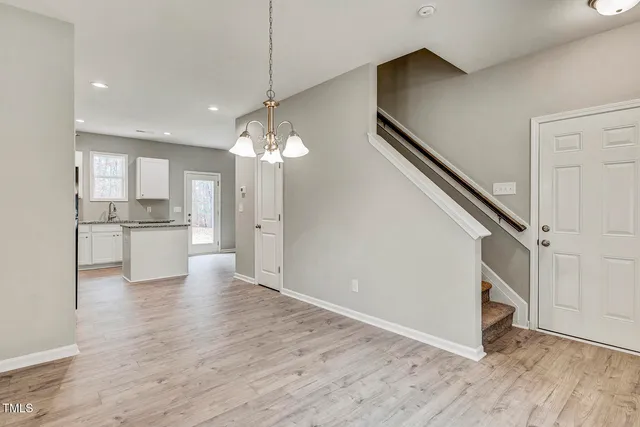 a view of a kitchen with a sink and dishwasher cabinets with wooden floor