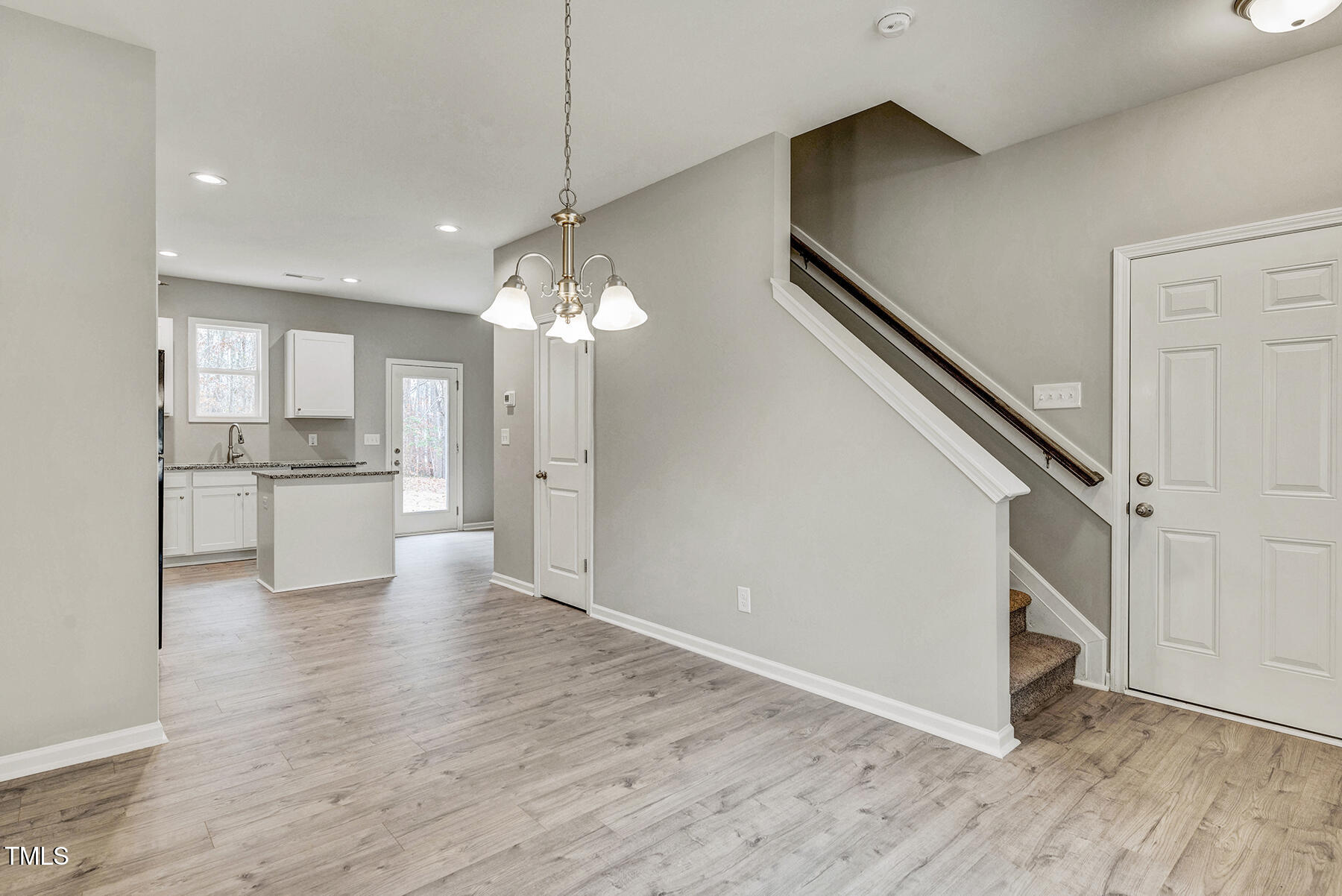 67 Stewarts Knob Drive Clayton, NC 27527 - Photo 13 of 26 a view of a kitchen with a sink and dishwasher cabinets with wooden floor