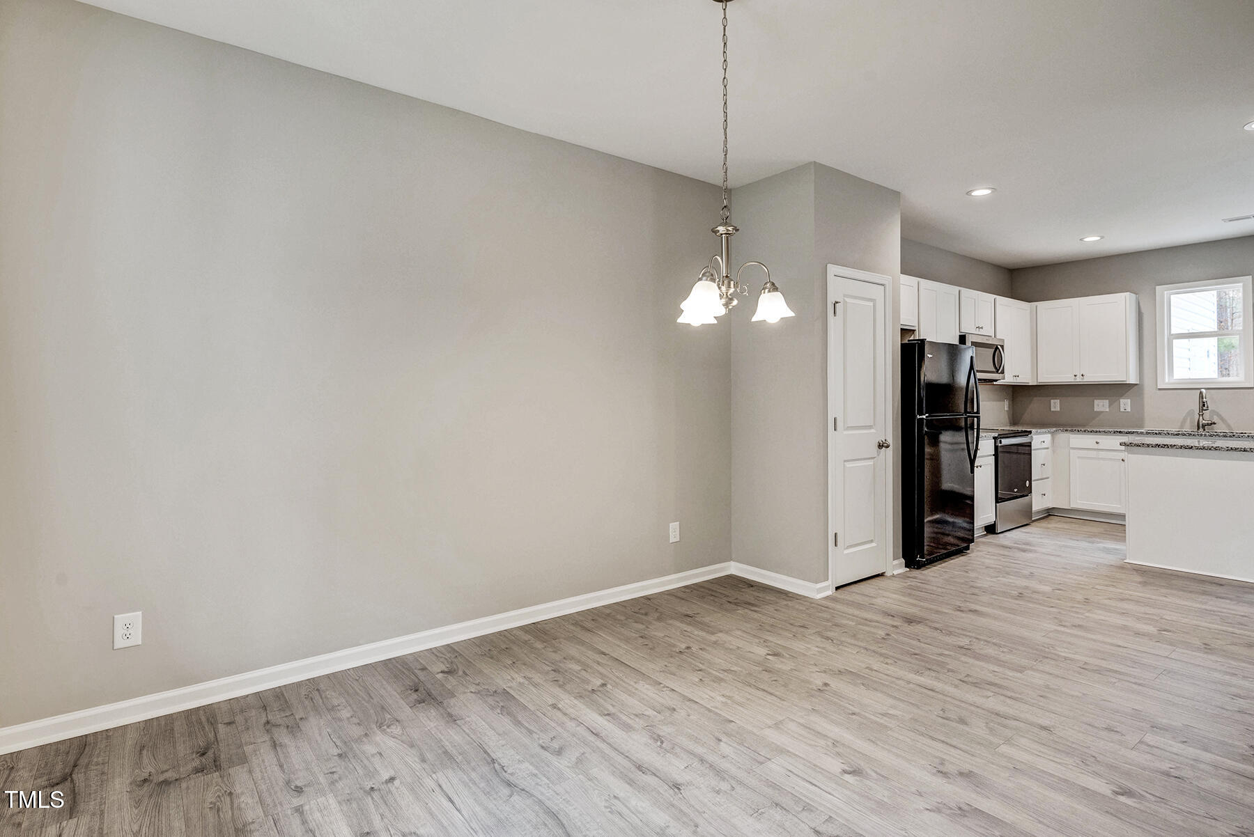 67 Stewarts Knob Drive Clayton, NC 27527 - Photo 14 of 26 a view of a kitchen with a refrigerator a ceiling fan and wooden floor